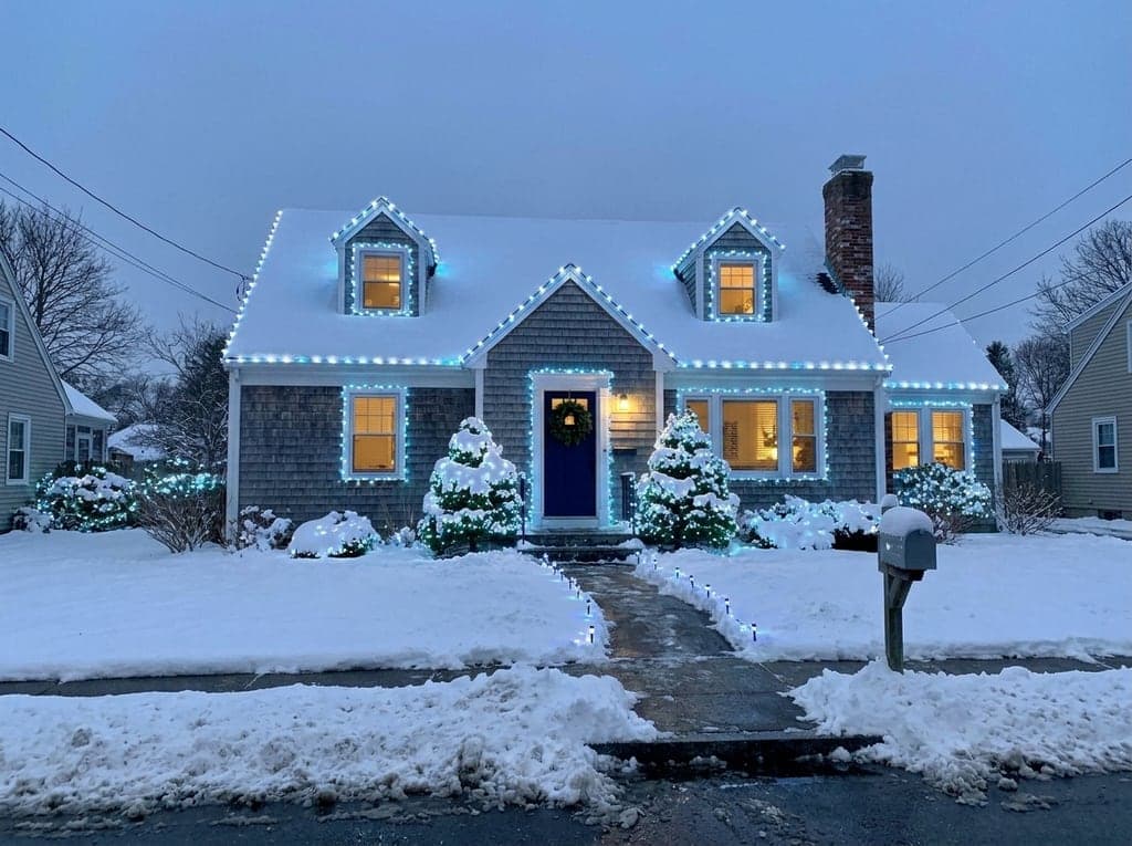 Cape Cod house in snow, cool white and blue